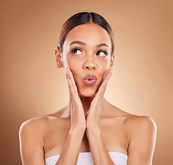 Image showing Beauty, thinking and a woman with hands on face for skin care glow and shine in studio on brown background. Aesthetic female model with spa facial, dermatology cosmetic and wellness wow idea