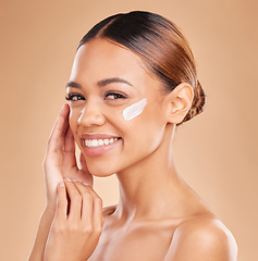 Image showing Face, skincare portrait and woman with cream in studio isolated on a brown background. Dermatology, beauty cosmetics and happy female model with lotion, creme or facial moisturizer for skin health.