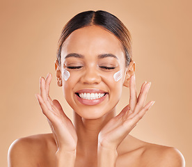 Image showing Face smile, skincare and woman with cream in studio isolated on a brown background. Dermatology, beauty cosmetics and happy female model with lotion, creme or moisturizer product for skin health.