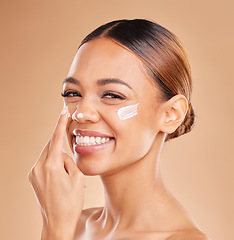 Image showing Skincare portrait, face and woman with cream in studio isolated on a brown background. Dermatology, beauty cosmetics and happy female model with lotion, creme or facial moisturizer for skin health.