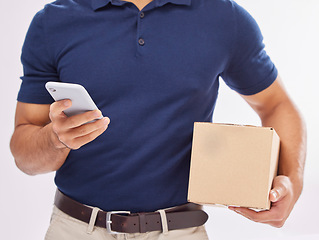 Image showing Delivery man with package in hands, phone and box, ecommerce and shipping isolated on white background. Communication, fintech and zoom, digital invoice and male in studio with commercial service