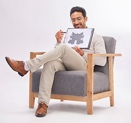 Image showing Psychology, psychologist and man with rorschach test diagram on clipboard in studio isolated on a white background. Therapist, consultant or happy male sitting on chair with document for inkblot exam