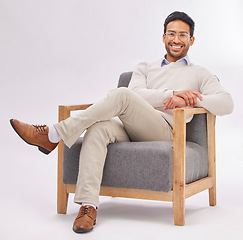 Image showing Confident, chair and portrait of entrepreneur sitting happy with a smile and crossed legs isolated in studio white background. Gentleman, relax and professional or proud male employee or business man