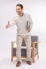 Image showing Handshake offer of professional man isolated on a white background, welcome meeting or psychologist client hello. Asian person or therapist shake hands in deal or introduction with armchair in studio