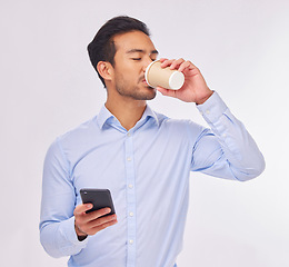 Image showing Phone, drinking coffee and business man in studio isolated on a white background. Cellphone, tea break and male professional with smartphone for social media, web browsing or typing on mobile app.