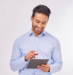 Image showing Typing, smile and business man with tablet in studio isolated on a white background. Professional, technology and happy male with touch screen for social media, research or internet browsing online.