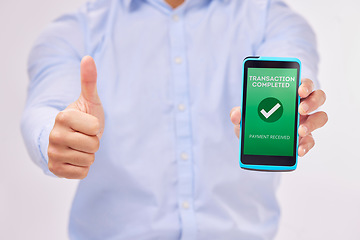 Image showing Man, hands and phone with thumbs up for transaction approval against a white studio background. Hand of male showing thumb emoji, yes sign or like for electronic purchase or ecommerce on smartphone