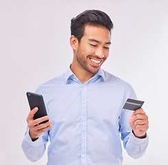 Image showing Man with smartphone, credit card and smile for ecommerce, fintech and online shopping isolated on white background. Payment, internet banking and technology with bank app and happy male in studio