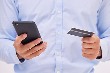 Image showing Man, ecommerce with smartphone and credit card in hands, closeup with fintech and online shopping isolated on white background. Payment, internet banking and technology, bank app and male in studio