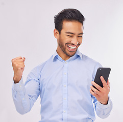 Image showing Winner, celebration and business man with phone in studio isolated on a white background. Success, cellphone and happy male professional celebrating, bonus or winning prize, competition or lottery.