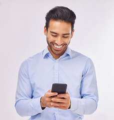 Image showing Smile, phone and business man typing in studio isolated on a white background. Cellphone, web networking and happy male professional with smartphone for reading, social media or mobile app online.