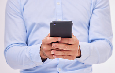 Image showing Business man, hands and typing with phone in studio isolated on a white background. Cellphone, networking and male professional with smartphone for texting, social media or internet browsing online.