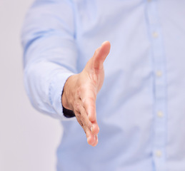 Image showing Opportunity, welcome and business man with a handshake in studio for recruitment, onboarding or hiring. Partnership, collaboration and male professional shaking hands for contract, agreement and deal