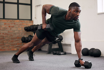 Image showing Black man, dumbbell row and training in gym, workout and strong fitness in health club. Serious sports athlete, bodybuilder and weight exercise on ground for energy, power and core strength challenge