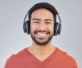 Image showing Call center, portrait and man consultant in studio happy while working in crm, faq or telemarketing on grey background. Face, online, support and customer service agent consulting for virtual startup