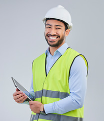 Image showing Construction worker, portrait and happy man in studio with tablet and helmet safety on white background. Smile, internet and contractor or architect in online planning for project management in India