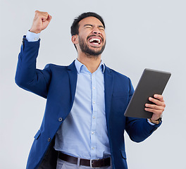 Image showing Winner, excited and tablet with man in studio for good news, success and bonus. Pride, yes and celebration with male and cheering isolated on gray background for achievement, pride and job promotion