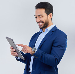 Image showing Smile, tablet and asian businessman in studio reading email, networking and internet on white background. Connect, online report and man in suit, communication and technology for investor at startup.