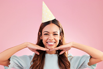 Image showing Birthday woman, face portrait and smile for happy celebration event, congratulations or celebrate happiness. Studio posing, party hat and headshot female, person or young model on pink background