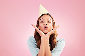 Image showing Birthday woman, face portrait and kiss for celebration event, congratulations or celebrate studio happiness. Emoji gesture, party hat and headshot female, person or young model on pink background