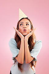 Image showing Birthday woman, studio and blowing kiss for celebration event, congratulations or celebrate happiness. Emoji gesture, party hat and relax female, person or young model looking on pink background