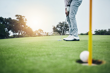 Image showing Ground, golf hole and man with golfing club on course for game, practice and training for competition. Professional golfer, sports and male athlete hit ball on grass for winning, score or tee stroke