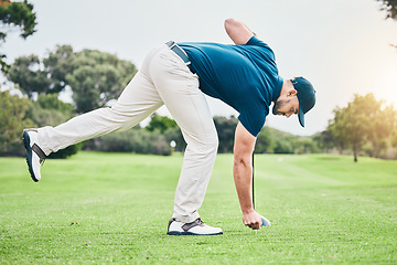 Image showing Man, golf ball and tee on grass to ready for game, sport or international competition with focus outdoor. Professional golfer, start and preparation for contest on field, lawn and course in summer