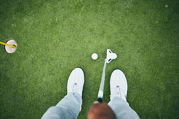 Image showing Grass, golf hole and man with club on course for game, practice and training for golfing competition. Professional golfer, sports and top view of male shoes hit ball for winning, score or tee stroke