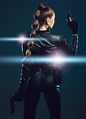 Image showing Warrior, woman and gun to fight in studio for action or danger on dark background. Strong female model, assassin or agent in scifi futuristic cosplay costume with weapon as ninja or vigilante mission