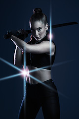 Image showing Warrior, woman and sword portrait to fight in studio for action on dark background. Strong female model, assassin or agent scifi futuristic cosplay costume with weapon as ninja or vigilante mission