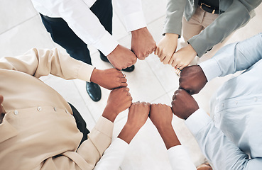 Image showing Mission, circle or business people fist bump for partnership or motivation in office meeting together. Diversity, top view or employees with teamwork, strategy or group support for project goal