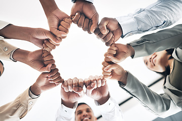 Image showing Team building, circle or business people hands in fist for motivation in office meeting together. Diversity, low angle or happy employees with mission, strategy or group support for project planning