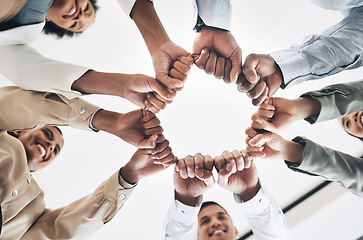 Image showing Team building, circle or happy business people fist bump for motivation in office meeting together. Diversity, low angle or employees with mission, strategy or group support for project goal