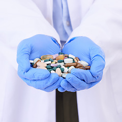 Image showing Hands, healthcare or pills with a doctor in clinic holding medication for the treatment of disease. Medical, hospital or tablets with a variety of medicine in the hand of a professional health worker