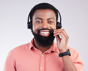 Image showing Portrait, call center and black man with headset, telemarketing and customer service against a studio background. Face, African American male employee and consultant with headphones and tech support