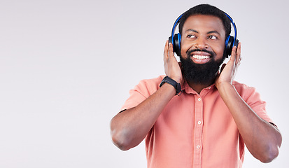 Image showing Black man, studio mockup space and headphones for music to relax, listen and streaming by background. Happy african model, audio and sound for peace, mindfulness and online podcast with smile on face