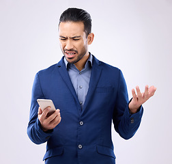 Image showing Employee, smartphone and Asian man with stress, glitch and connection issue against studio background. Male entrepreneur, consultant or ceo with cellphone, problems or online reading with frustration