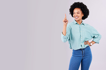 Image showing Mockup, copy space and black woman point in studio for advertising, product placement and branding. Happy, smile and isolated female pointing on white background for show, choice and promotion sign