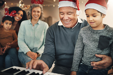 Image showing Music, christmas and senior man with grandchild on piano for learning, teaching and bond in their home. Family, instrument and retired pianist performing for kids and parents in festive celebration