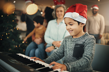 Image showing Boy, music keyboard and christmas in family home with smile, playing and creative skill with grandmother. Male kid, young musician and grandparents by piano for holiday cheer, bond and pride in house