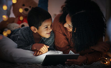 Image showing Mother, son and tablet on bed in night with smile, streaming movies and bond with happiness, love or care. Woman, boy child and mobile touch screen in bedroom for story, video or happy in family home