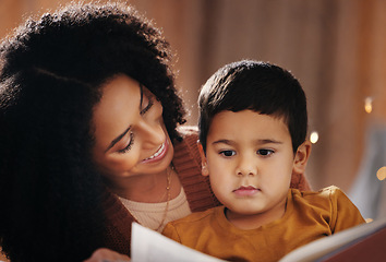 Image showing Night, book and mother with child in bedroom for bedtime storytelling, fairytale and education. Reading, happiness and smile with boy listening to woman at home for learning, creative and literature