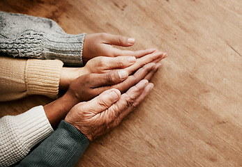 Image showing People, hands together and generations in support above on mockup for unity, compassion or trust on wooden table. Group holding hand in collaboration, love or care for community, teamwork or union