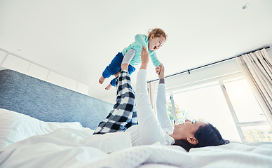 Image showing Bed, morning and a mother playing with her daughter in a bedroom of their home together for bonding. Family, kids or love with a woman and girl child having fun together after waking up on a weekend