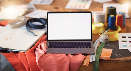 Image showing Mockup, design and a laptop screen for fashion, maunfacturing and clothing tailoring. Creative, blank and computer on a table for creativity, clothes ideas and styling for a dressmaker or designer