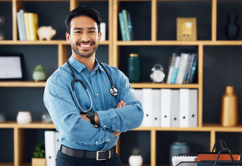 Image showing Portrait, Asian man and doctor with healthcare, arms crossed and success in workplace. Face, Japanese male employee and happy medical professional with leadership, management and happiness in office