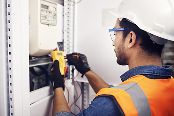 Image showing Technician, man and multimeter testing power for electricity, energy inspection and electrical system. Electrician, engineering and voltage test tool for machine, industrial mechanic and control room