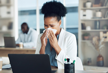 Image showing Work, healthcare and black woman at desk blowing nose with tissue paper from flu, cold or hay fever. Sick, exhausted office employee with allergy and sinus problem, health risk from illness at laptop