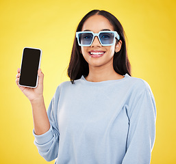 Image showing Phone, fashion and portrait of woman with sunglasses in yellow studio for social media, website and internet. Communication, mockup space and happy girl on smartphone for chat, promotion and network