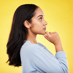 Image showing Woman, profile and studio with a young model thinking with casual fashion feeling relax. Isolated, yellow background and gen z female person with youth and healthy hair care posing and relaxing